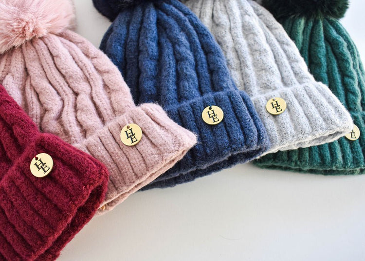 Collection of knitted equestrian beanie hats in red, pink, navy, grey, and green with HALT Equestrian logo badges, accessories and gift cards collection